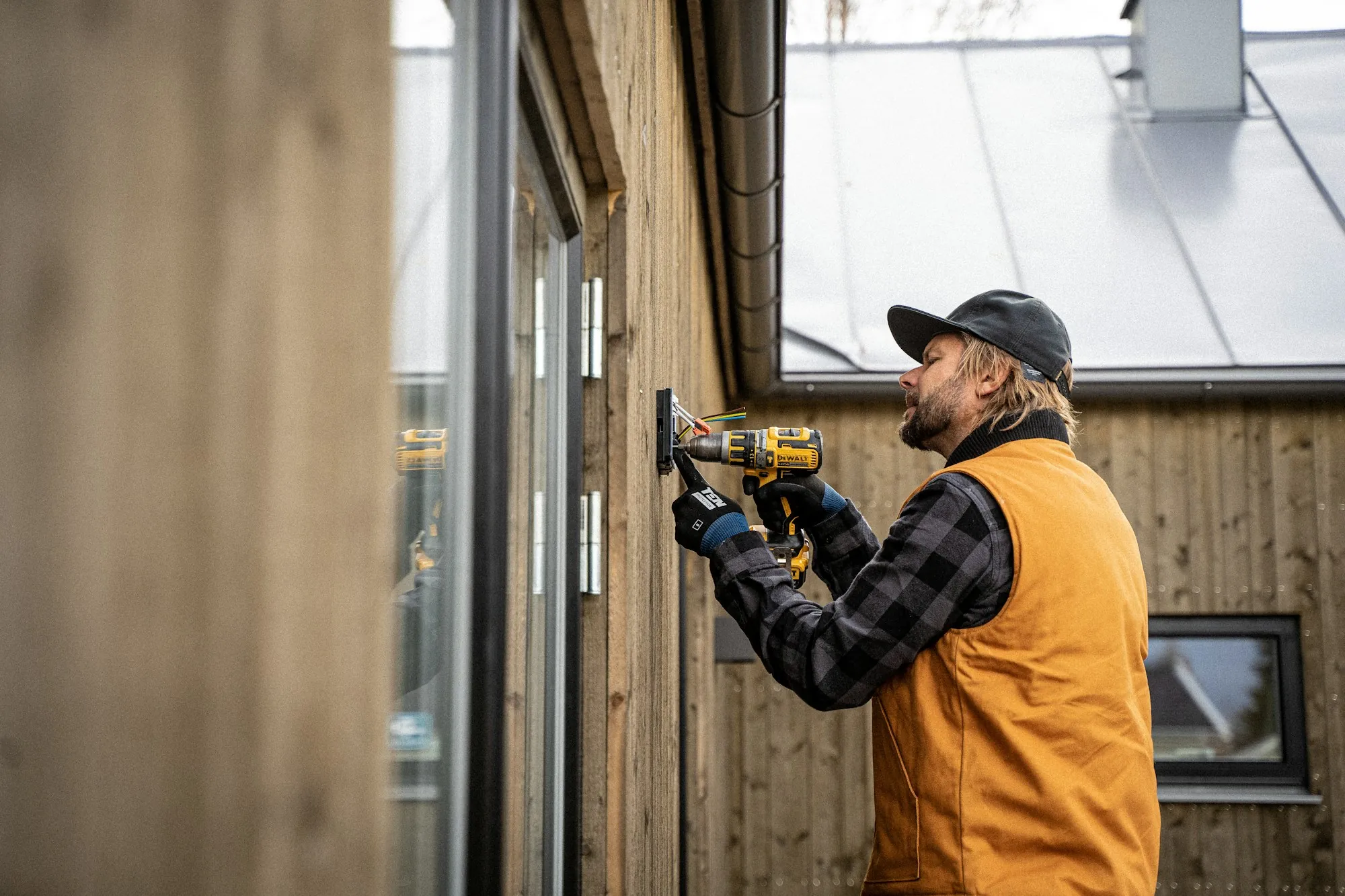 Electrician installing wiring on site