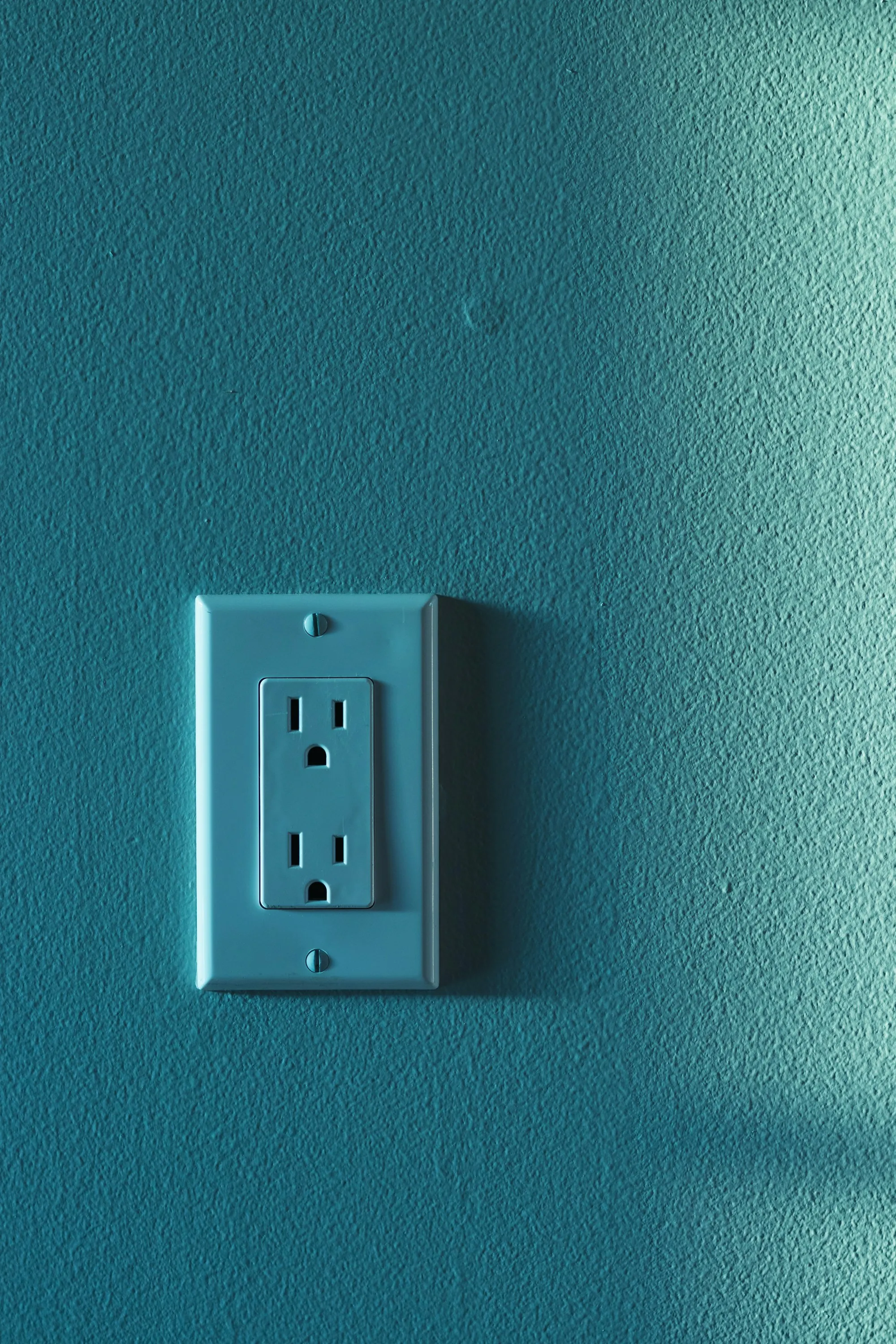 Electrical outlet and switch on a wall